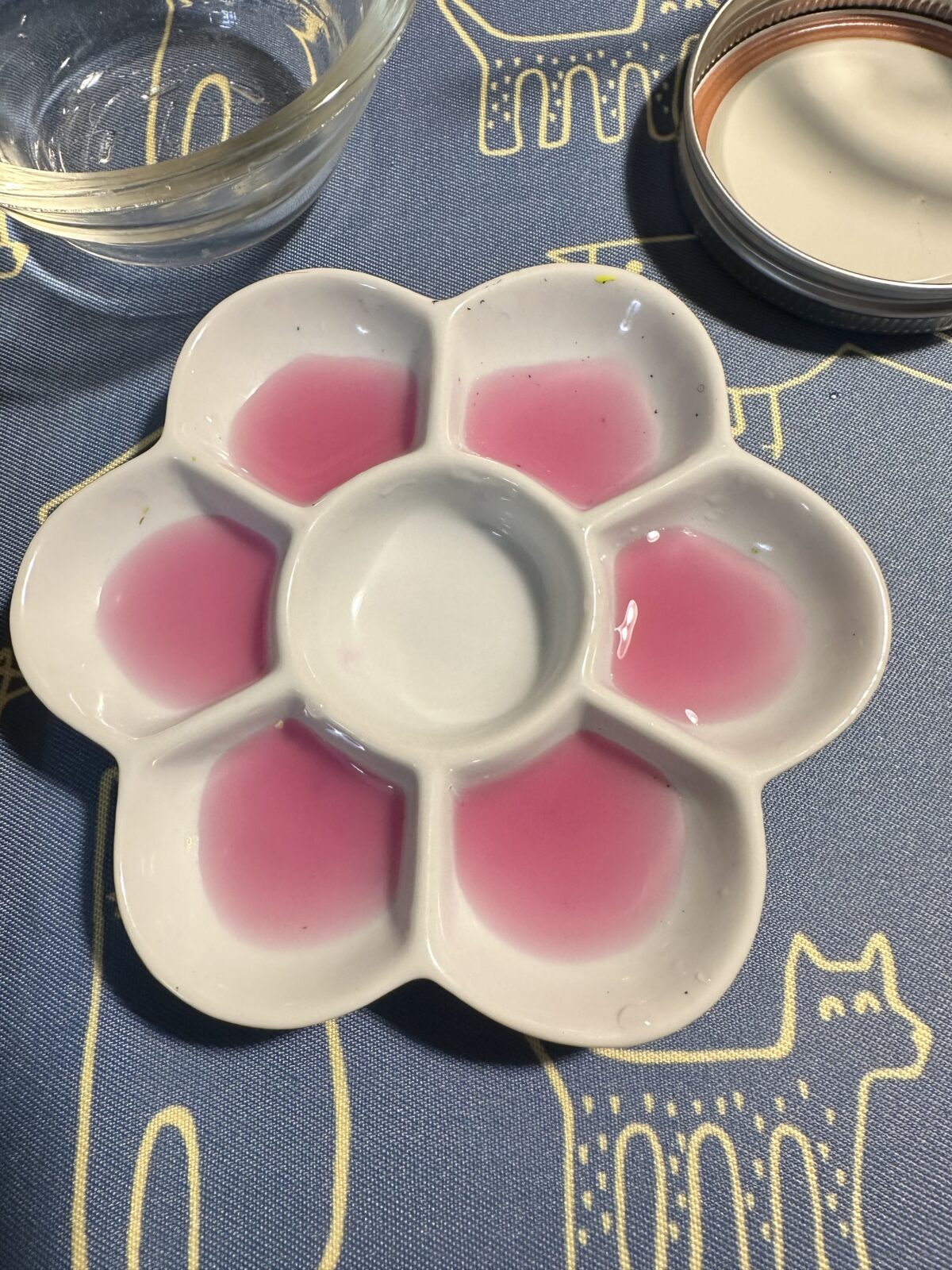 A porcelain watercolor palette filled with red juice from a red cabbage